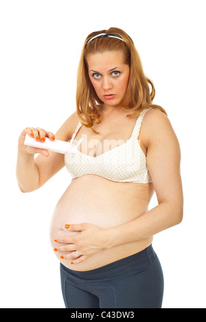 Pregnant woman pouring cream lotion on her belly isolated on white background Stock Photo