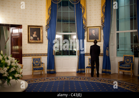 President Barack Obama looks at a portrait of President John Adams while waiting in the Blue Room prior to his press conference Stock Photo