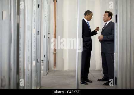 President Barack Obama talks with California Gov. Arnold Schwarzenegger during a tour of Solyndra, Inc Stock Photo