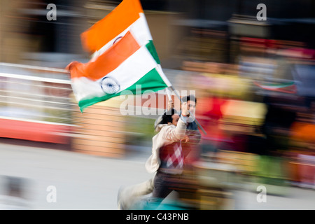 Patriot running with flag show just before Wagah border ceremony near to Pakistan,  Amritsar, Punjab, India Stock Photo