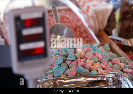 digital weighing scales on a sweet confectionery stall in a market Stock Photo