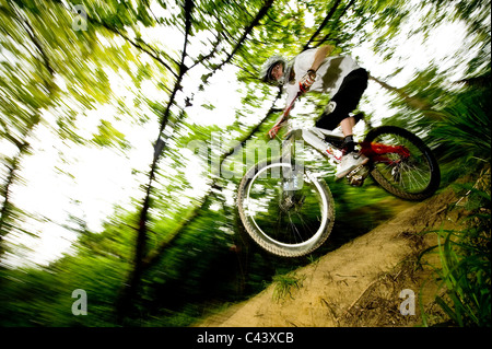 A young man downhill bicycling outdoor. Stock Photo