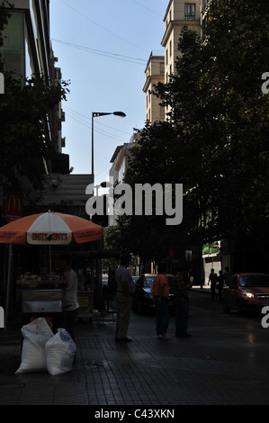 Dark shade urban street view people vendor selling fast-food roasted nuts ice-cream pop-corn, Paseo Ahumada, Santiago, Chile Stock Photo