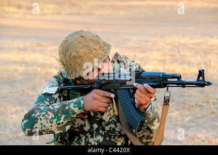 A border security force (BSF) personnel taking position with gun Stock Photo