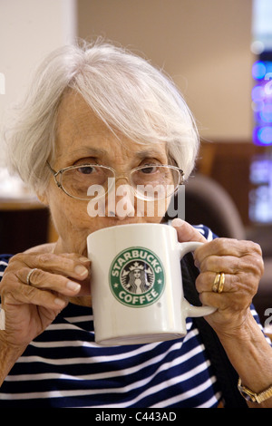 Elderly woman drinking Starbucks coffee Stock Photo - Alamy