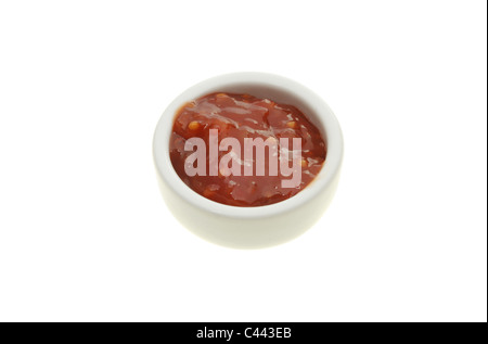 Tomato relish in a ramekin isolated against white Stock Photo