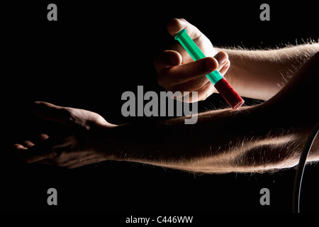 Man taking a blood sample from his arm