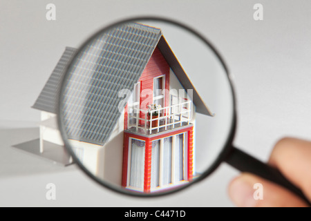 A model house viewed through a magnifying glass Stock Photo