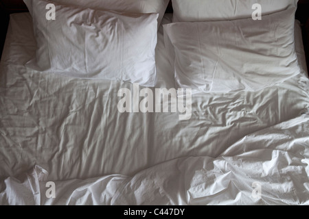 Detail of an unmade double bed Stock Photo