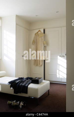 White bedroom with daybed and built in wardrobes Stock Photo