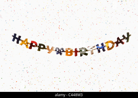 A hanging banner spelling HAPPY BIRTHDAY with confetti Stock Photo