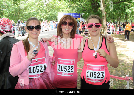 Mother and two daughters show their medals after finishing Race for LIfe in Regent's Park, London, on Sunday 22nd May 2011 Stock Photo