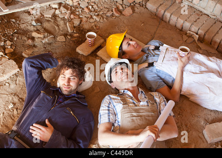 Three construction workers taking a coffee break Stock Photo