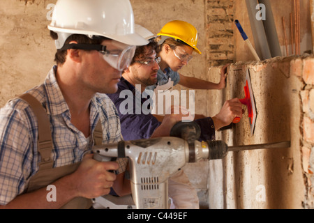 Manual workers working at a building site Stock Photo