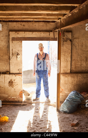 A manual worker standing in a doorway, portrait Stock Photo