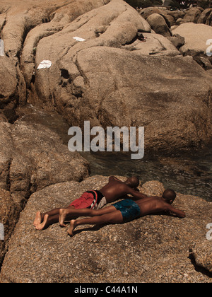 Two men sunbathing on South Beach, Miami Beach, Gold Coast, Florida