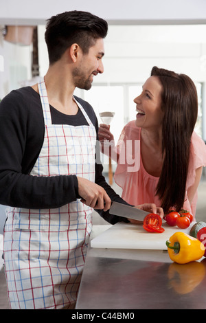 A young couple having fun while cooking Stock Photo
