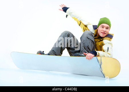 Portrait of young man going in for snowboarding in winter Stock Photo