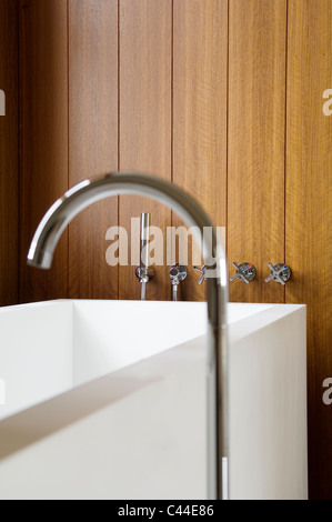 Corian bathtub with taps set in to the wall panelling Stock Photo