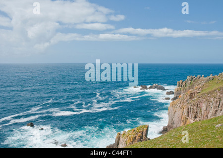Waves breaking on the rocks at Lands End Cornwall England Stock Photo