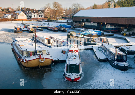 Boats Moored at Northwich Marina on the Iced up River Weaver in Winter, Northwich, Cheshire, England, UK Stock Photo