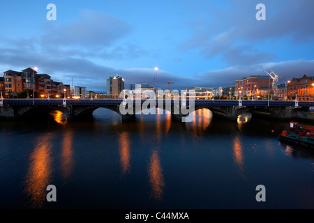 the queens bridge river lagan and laganside waterfront in the early morning blue hour in Belfast Northern Ireland UK Stock Photo