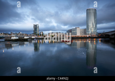 the boat obel tower river lagan weir and laganside waterfront in the early morning blue hour in Belfast Northern Ireland UK Stock Photo