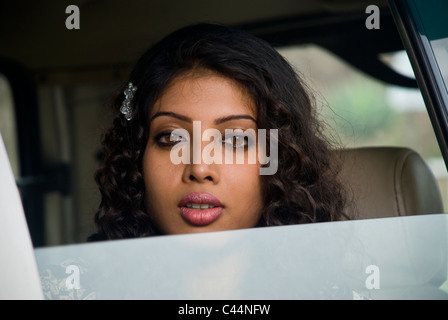 An Indian girl looking through the car window Stock Photo