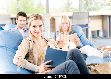 Portrait of high school female student hold book - classmates in backround Stock Photo