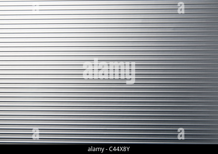 view of a gray metal surface with regular grooves Stock Photo