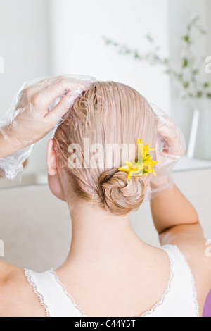 Woman applying hair mask Stock Photo