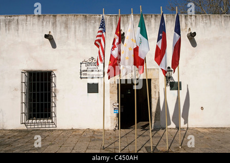 U.S.A, Texas, San Antonio, Spanish Governor's Palace, Six flags outside entrance of white building Stock Photo