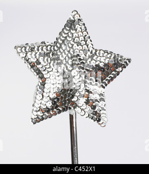 Magic wand star shaped with silver sequins Stock Photo