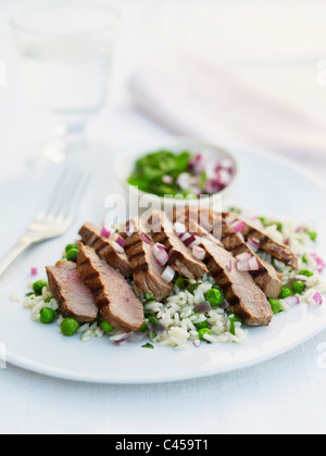 Sliced steak with rice on plate, close-up Stock Photo