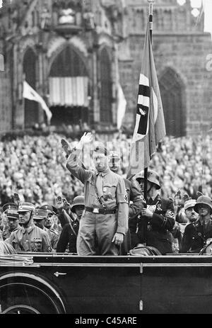 At the Nuremberg Rally, Adolf Hitler is seen saluting the 'Blutfahne ...