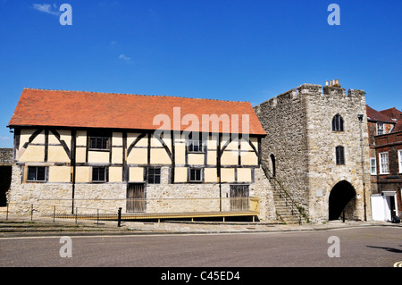 The15th Century medieval timber framed Tudor Merchants Hall stands alongside the fortified stone tower of Westgate, Southampton Stock Photo