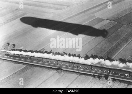 Race between an express train and an airship, 1911 Stock Photo