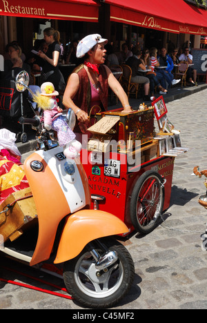 A woman playing a barrel organ and singing in Montmartre in Paris Stock Photo