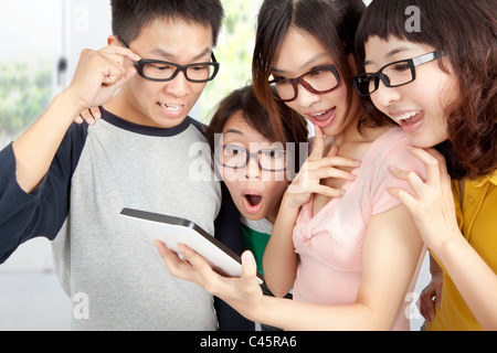 young group using tablet pc and surprised Stock Photo