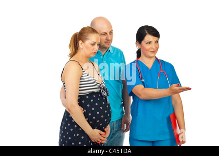 Doctor woman invite to join or showing something to a pregnant couple to right part of image isolated on white background Stock Photo