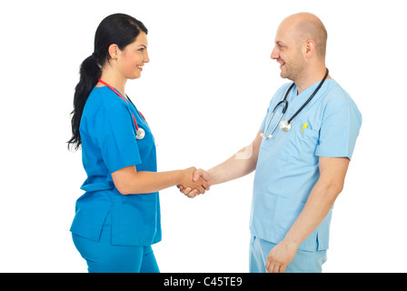 Happy two doctors giving handshake and smiling isolated on white background Stock Photo