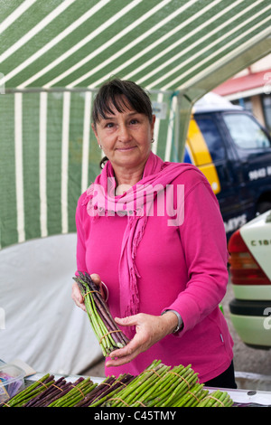 Stallholder selling organic asparagus at Albany Farmers Market. Albany, Western Australia, Australia Stock Photo
