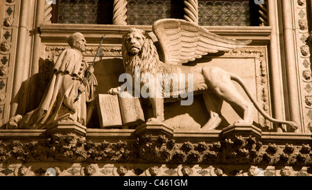 Venice - lion of St. Marc the Evengelist from portal of Doge palace - Porta Della Carta - Francesco Foscari Stock Photo