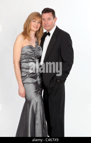 Couple wearing smart evening dress and suit with bow tie. Stock Photo