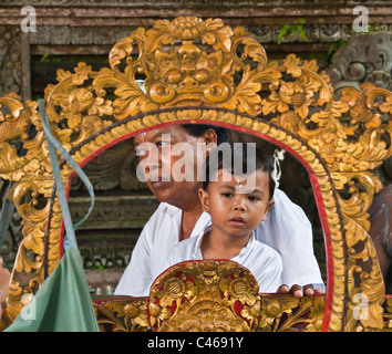 A BALINESE father and son at PURA BEJI in the village of Mas during the GALUNGAN FESTIVAL - UBUD, BALI, INONESIA Stock Photo