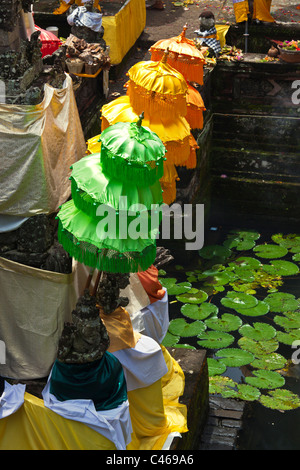 Colored umbrellas at the PURA BEJI in the village of Mas during the GALUNGAN FESTIVAL - UBUD, BALI, INDONESIA Stock Photo