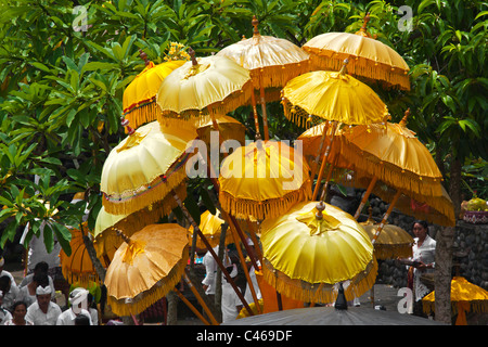 Colored umbrellas at the PURA BEJI in the village of Mas during the GALUNGAN FESTIVAL - UBUD, BALI, INDONESIA Stock Photo