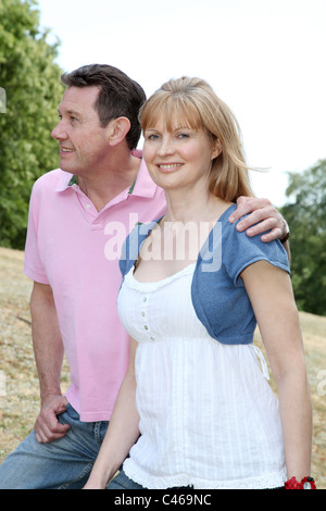 Couple walking in the countryside, smiling. Stock Photo