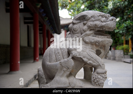 Male lion guard holding a ball in Beijing, China Stock Photo