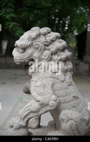 Male lion guard holding a ball in Beijing, China Stock Photo